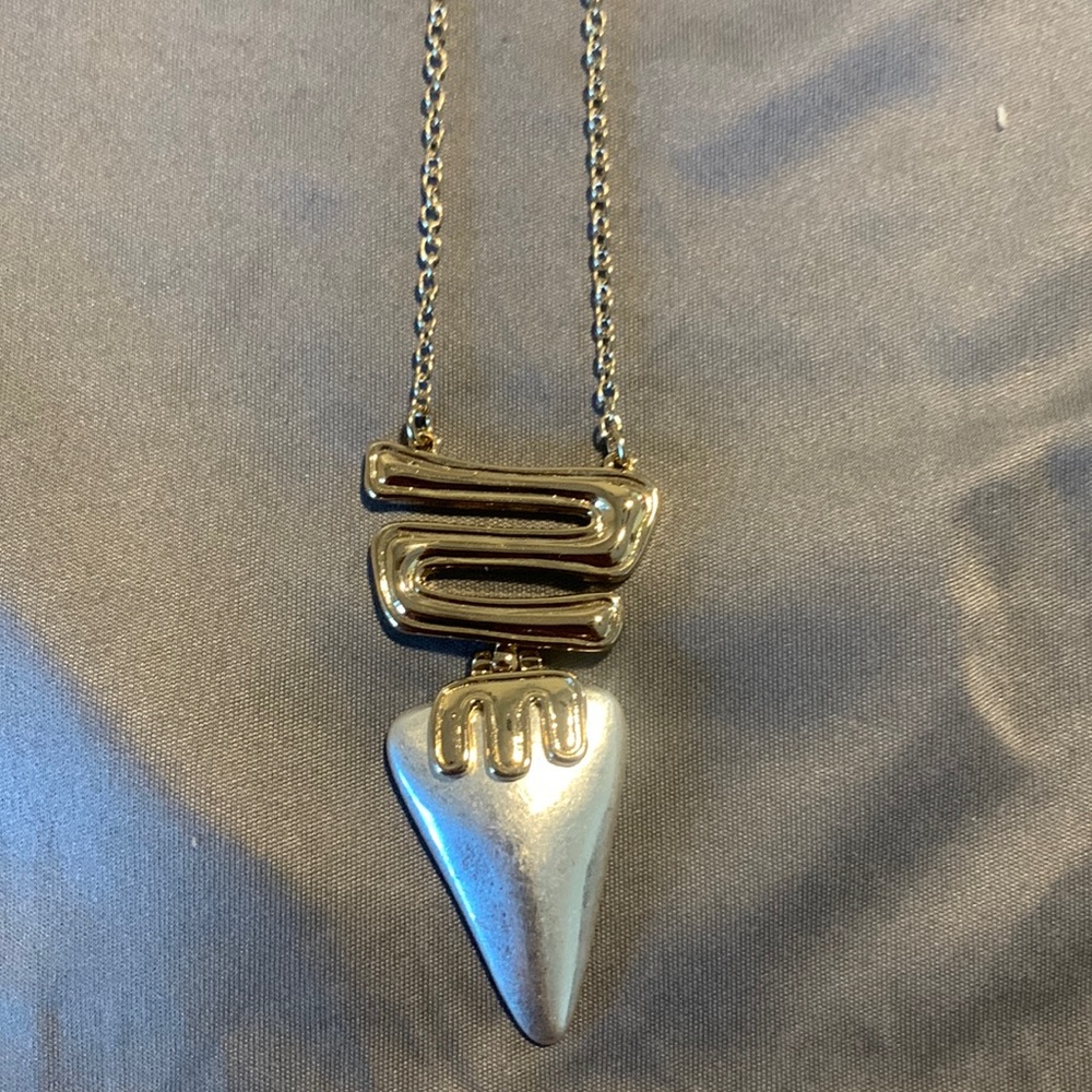 Long gold plated necklace with silver shark tooth shaped pendant